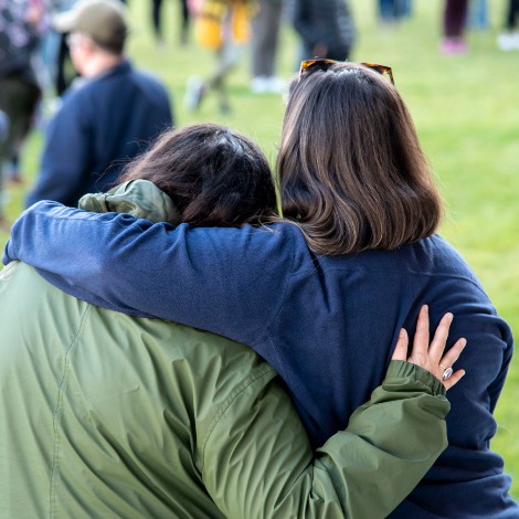 At a vigil on the Bean Green in Portland, people in the crowd leaned on each other for emotional support as they remembered the victims of a mass shooting in Lewiston.
