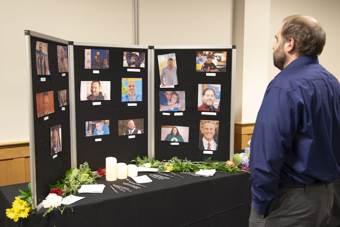 Guests to a vigil at the LAC Campus paid their respects in front of a photo board featuring the people who died in a mass shooting in Lewiston.