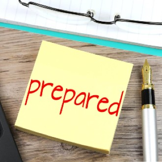 Yellow sticky note with the word "prepared" written in red ink