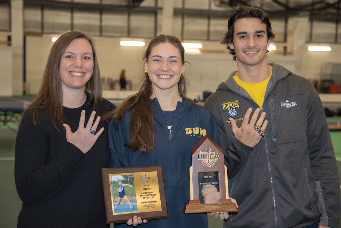 Track and Field standouts Emily Artesani Walton, Sophia Slovenski, and Ben Drummey flash the awards they received at a ceremony timed to coincide with the Department of Athletics' 100th anniversary.