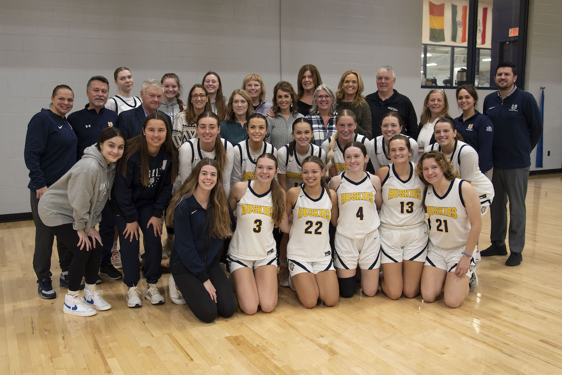 After their induction into the Little East Conference Hall of Fame, members of the 1987-88 women's basketball team pose with the current squad.