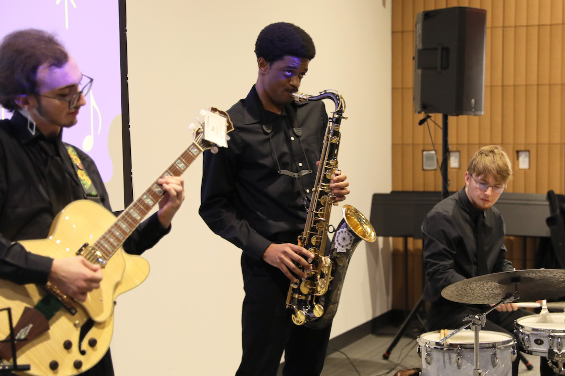 A jazz combo of Ry Johnson, Jorge Allen, and Miles Plummer perform at the 2023 Osher Gala