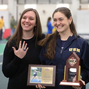 Track and Field standouts Emily Artesani Walton and Sophia Slovenski display the awards they received as part of the festivities to celebrate the 100th anniversary of USM Athletics.