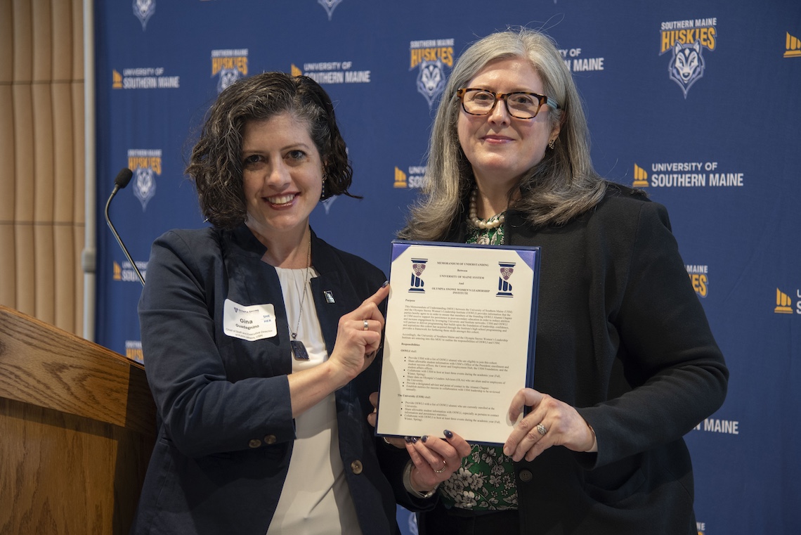 OSWLI Executive Director Christina McAnuff and Gina Guadagnino, chief of staff to the USM president, display a newly signed charter establishing USM's first alumni chapter of the Olympia Snowe Women's Leadership Institute.