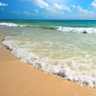 Ocean wave coming up onto a sandy beach