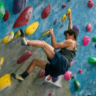 Person climbing up a rock climbing wall