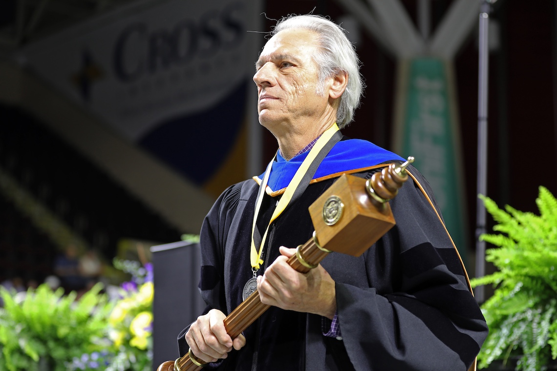 The ceremonial mace arrives at the podium to begin the 2024 Commencement ceremony.
