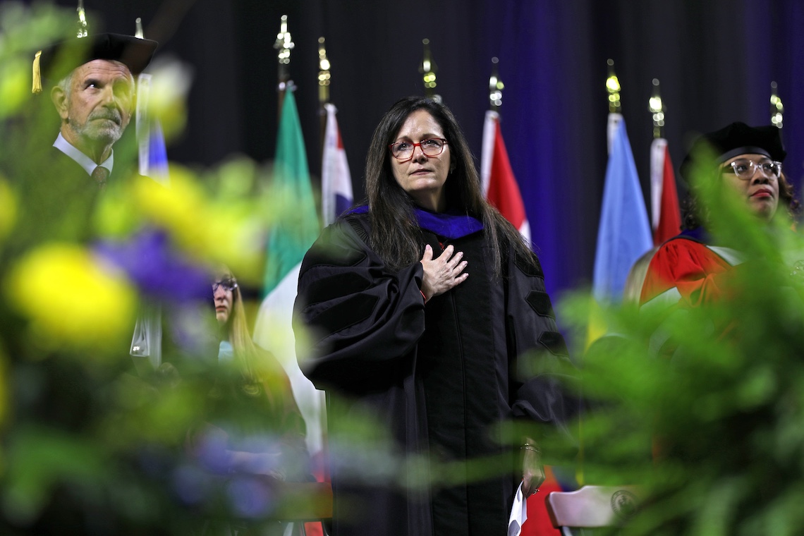 President Jacqueline Edmondson holds her hand over her heart during the National Anthem at the 2024 Commencement ceremony.