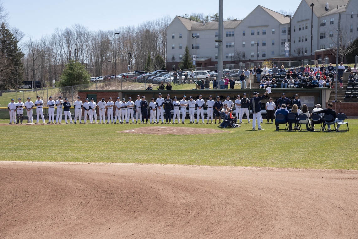 The USM baseball stands along the first base line as a show of respect for Coach Ed Flaherty at his retirement ceremony.