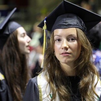 A graduate waits her turn to walk across the stage and collect her diploma at the 2024 Commencement ceremony.