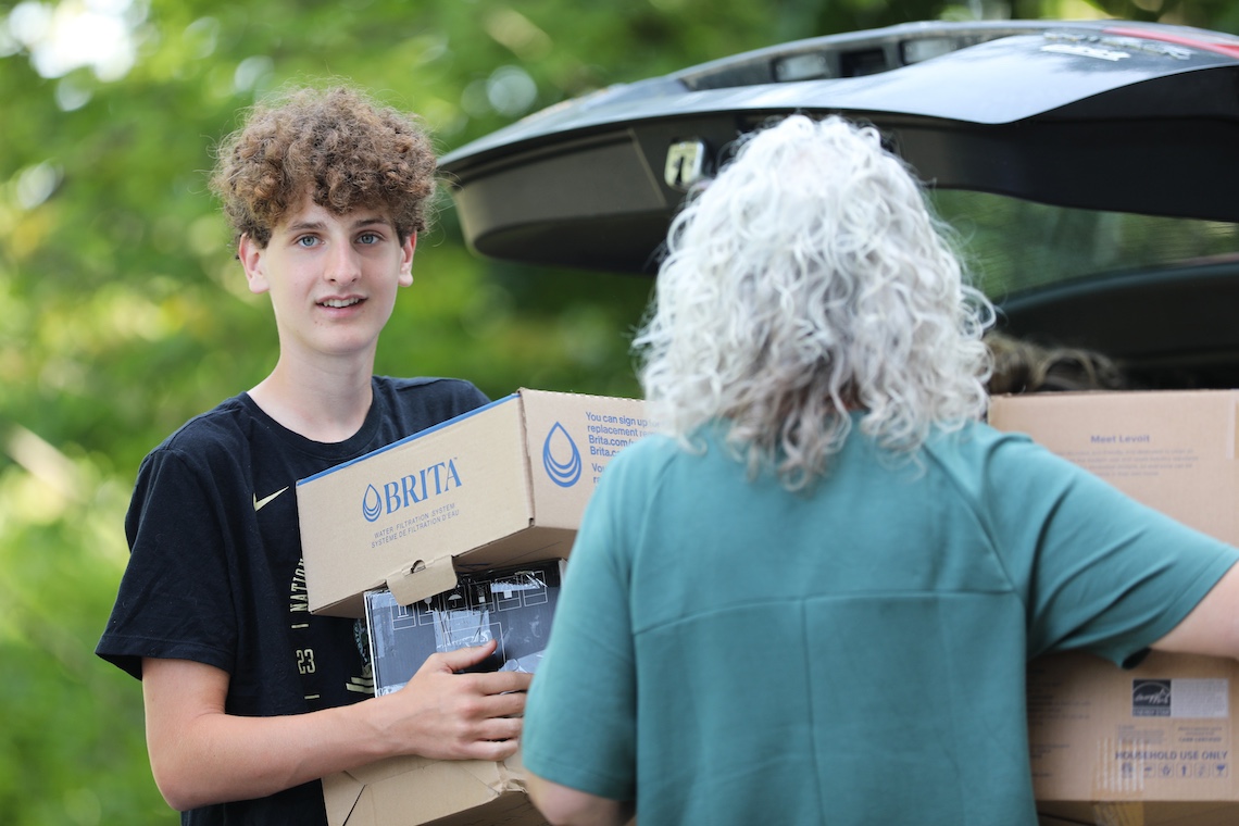 Out of the car and into the dorm at Anderson Hall goes another load of belongings on the first day of Move-In Weekend.