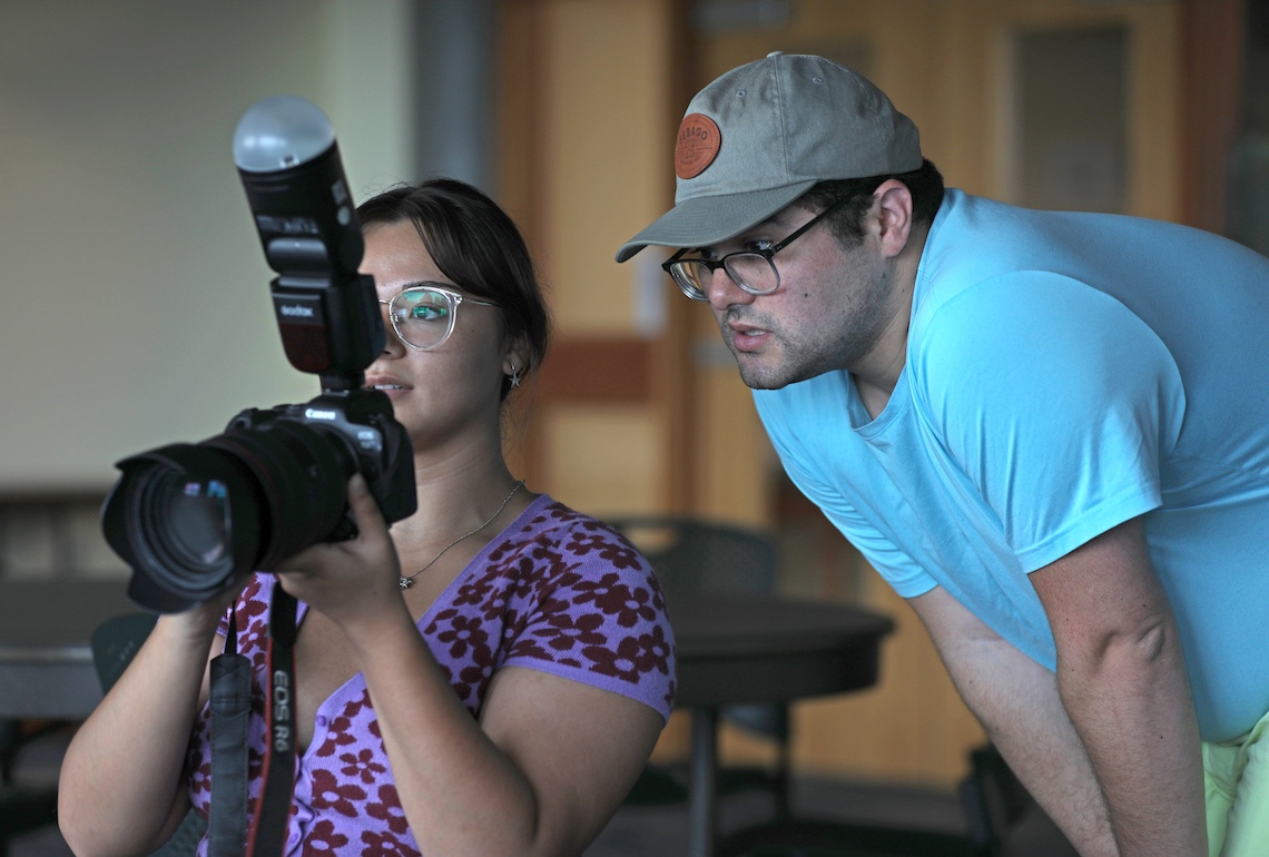 Taylor Gervais ('17) reviews a photo at a promotional shoot for "Legally Blonde: The Musical," which he is directing for the Portland Players.