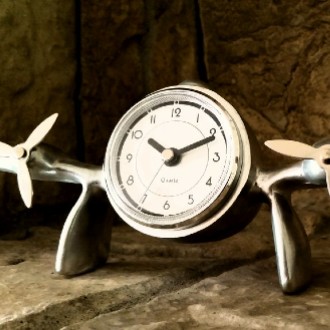 Small clock with propellers on either side of its face