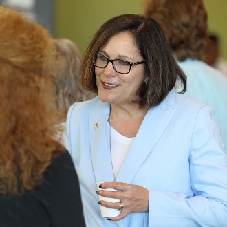 President Jacqueline Edmondson chats with guests at the 2024 Opening Breakfast.