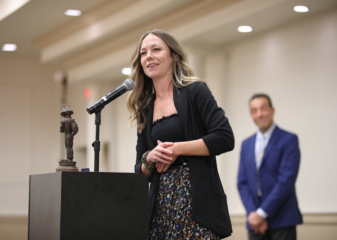 Lacrosse standout Jacki Kelly accepts her trophy and ring at the 2024 Husky Hall of Fame induction ceremony.