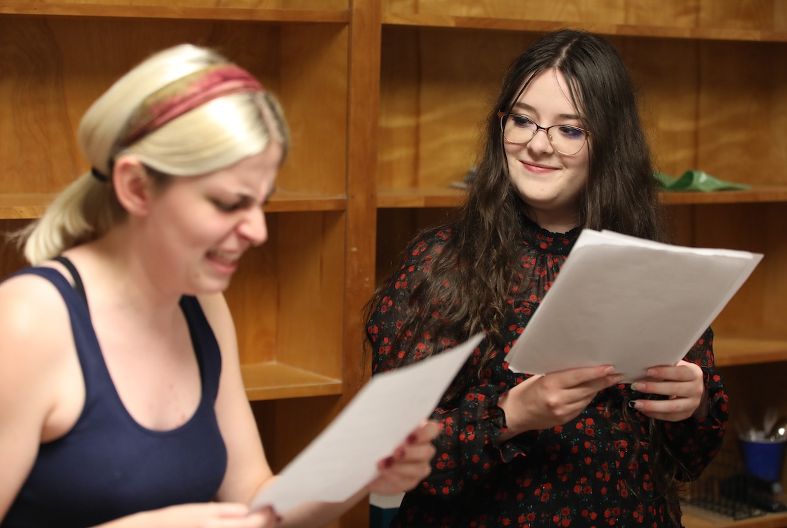 Salena Goodine cuts loose with a witch's cackle much to the amusement of Hailey Gagnon during a rehearsal for "The Wizard of Oz" radio play.