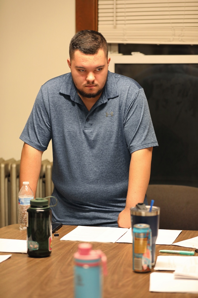 During a rehearsal for "The Wizard of Oz" radio play, Mike Lawrence assumes a menacing posture to help get into character for the title role.