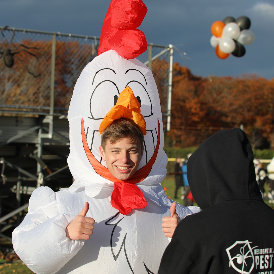 In keeping with the wrestling team's barnyard-themed costumes, Vinny Keeler dressed as a chicken at the Husky Community Howl-o-Ween Party.