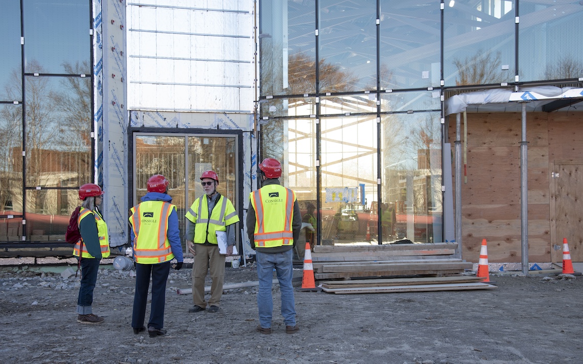 Visitors on a tour of the Crewe Center learn how the windows of the Great Hall Gallery are designed to admit natural light while repelling birds.