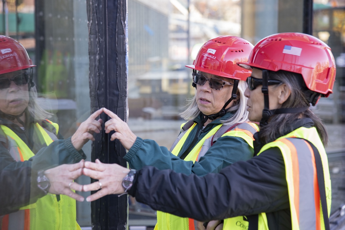 During a tour of the Crewe Center, visitors from Maine Audubon feel the acid-etched markings on the windows, which make the glass visible to birds.