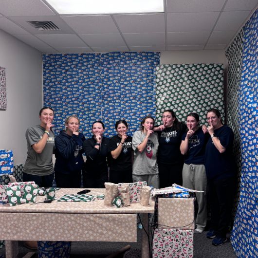 Several softball players played a holiday prank on Coach Sarah Jamo by gift wrapping her entire office.