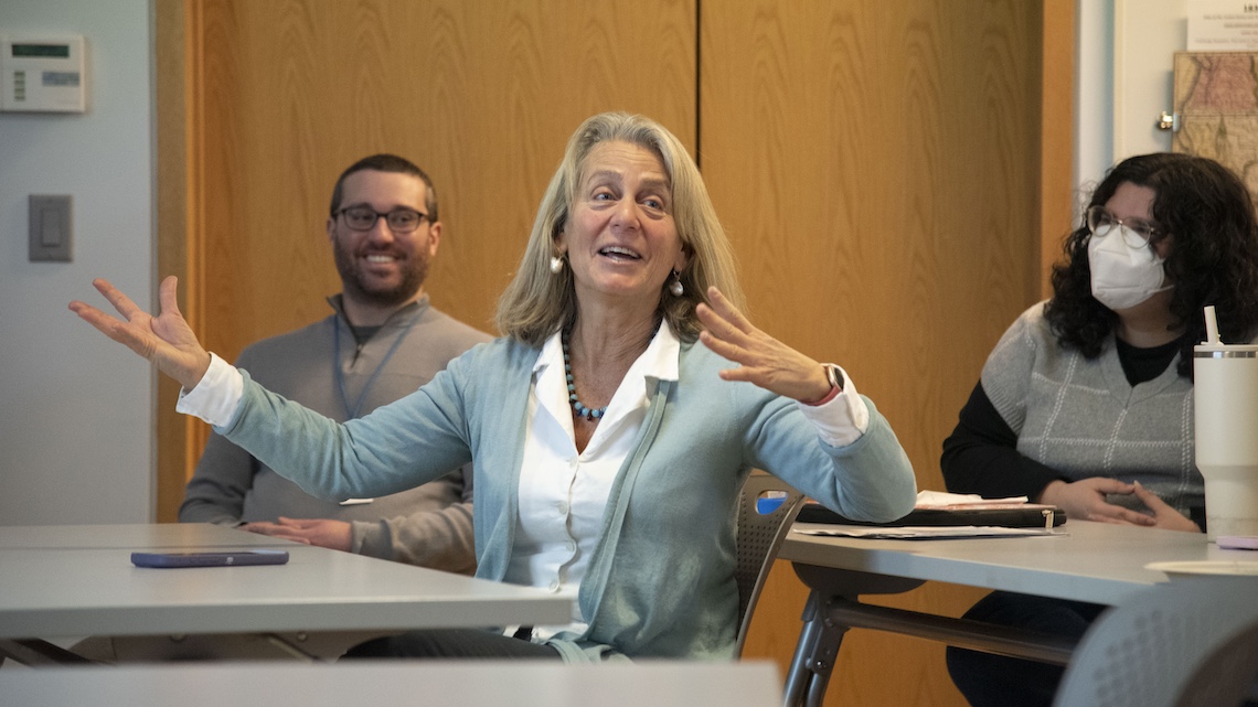 Dr. Paula Gerstenblatt commends her students on the maps they created to illustrate the complexities of student loan debt.