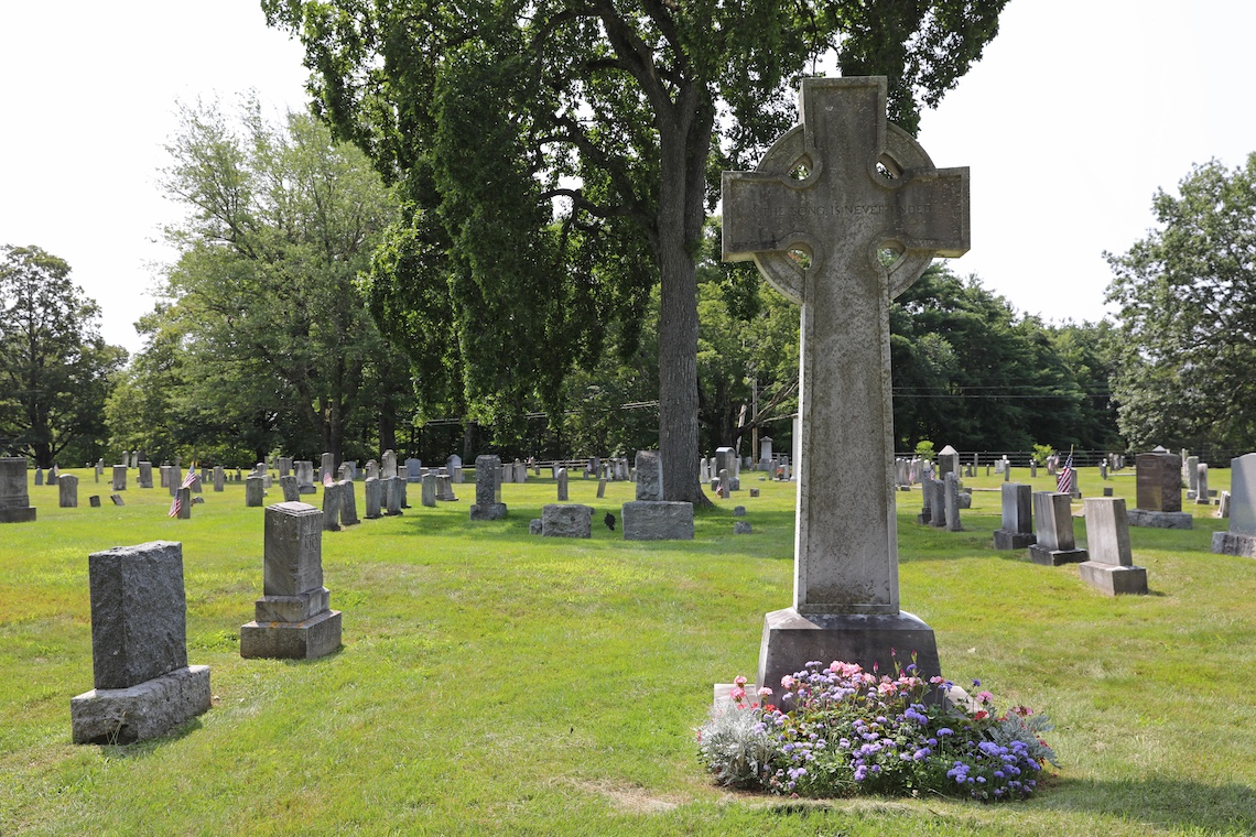 A Celtic cross memorializing Kate Douglas Wiggin towers over the other headstones at Tory Hill Cemetery in Buxton.