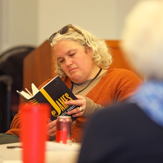 Dr. Libby Bischof skims a passage from "James" by Percival Everett during a meeting of the USM Reads book club.