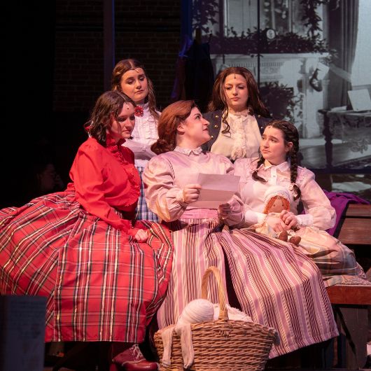 Marmee reads her daughters a letter from their father in a scene from "Little Women."