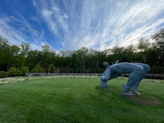 inSitu landscape with large sculpture of figure doing backbend