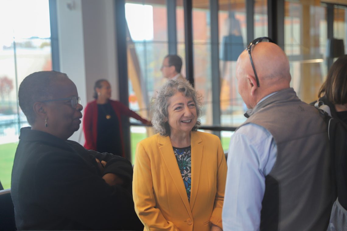 Caroline Paras speaks with local legislators ahead of the Economic Contribution Report presentation.