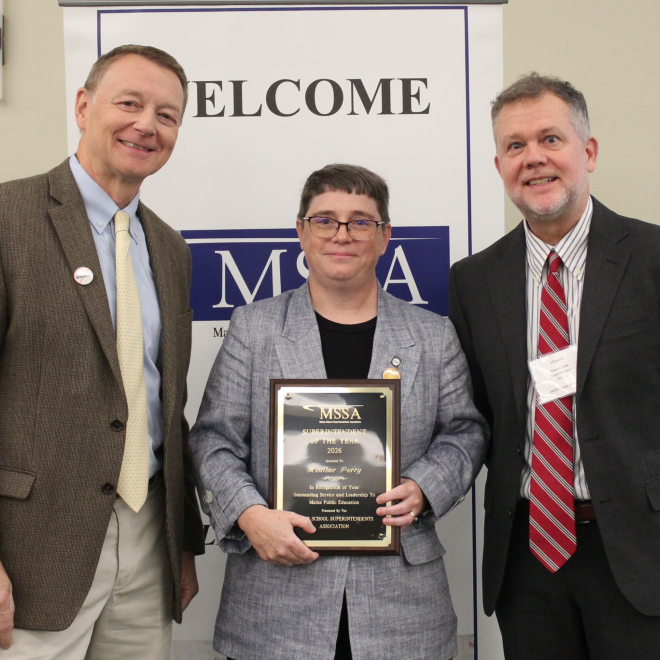 Heather Perry holds her award for Maine's 2026 Superintendent of the Year, accompanied by MSSA President Andrew Dolloff (left) and MSSA 2025 Superintendent of the Year Howard Tuttle (right).