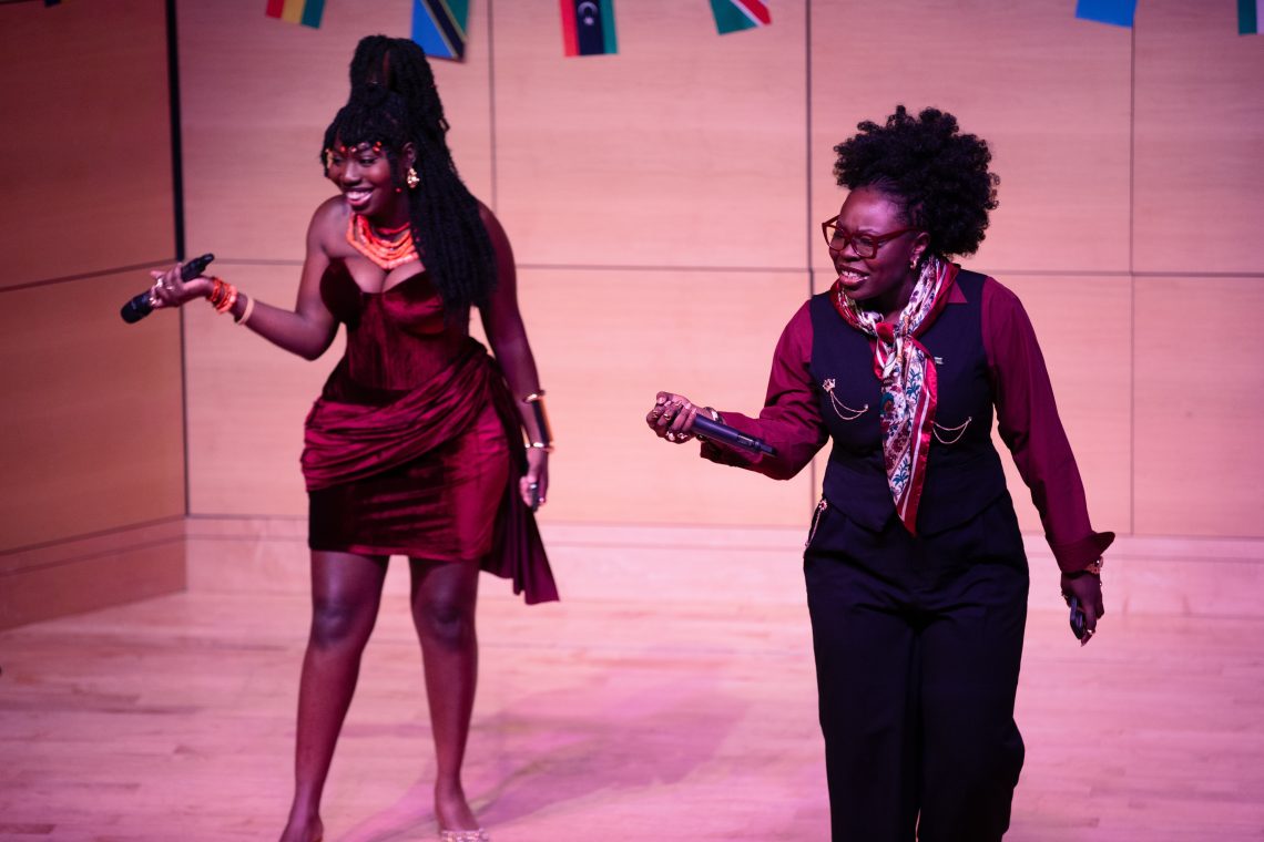 Hosts of Afrochella hold the mic to the audience