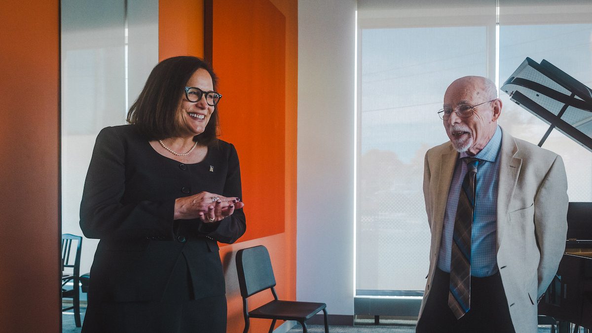 Dr. Steven Smith and President Jacqueline Edmondson smile together in Steven Smith Practice Room at the Crewe Center
