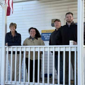 Staff at USM pose at new building