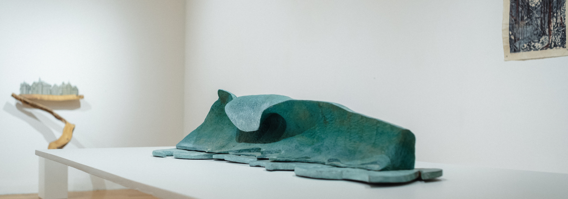 Lin Lisberger Exhibition featuring a painted blue wooden sculpture of a wave.