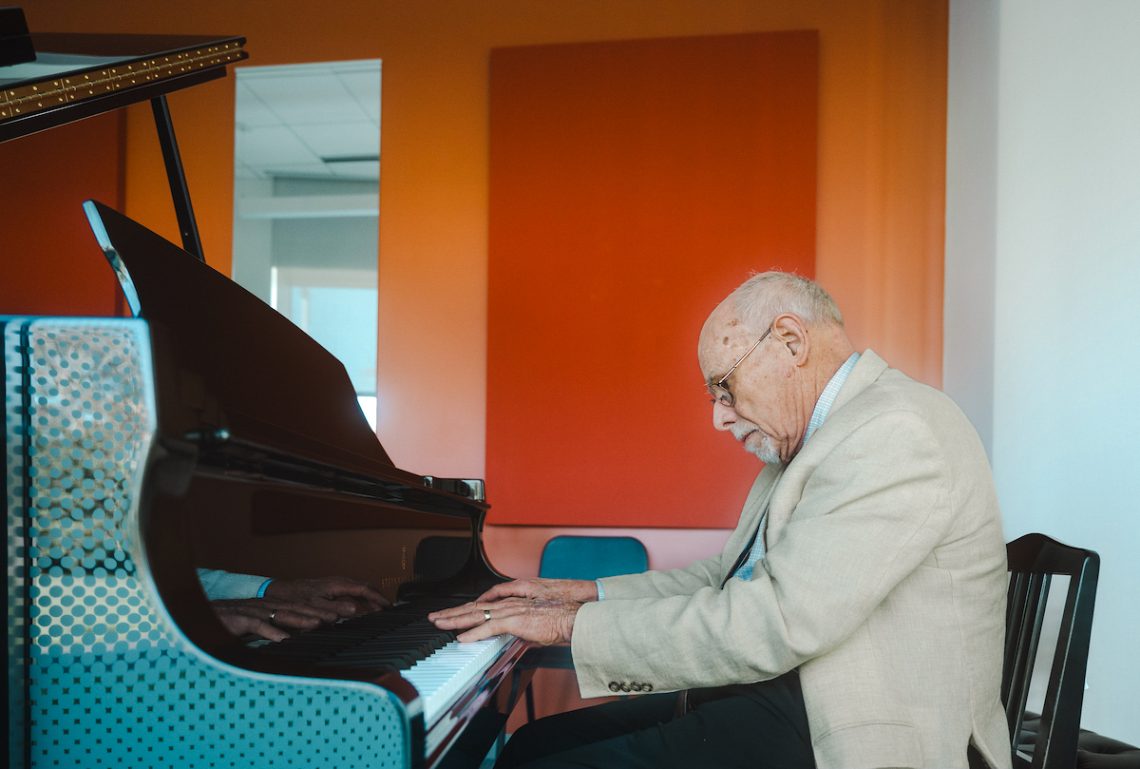 Dr. Steven Smith plays the piano in Dr. Steven Smith Practice Room at the Crewe Center