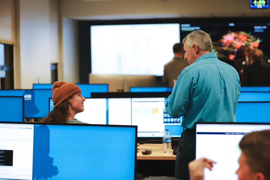 Student and professor talk at new SOC Cybersecurity Classroom Ribbon Cutting