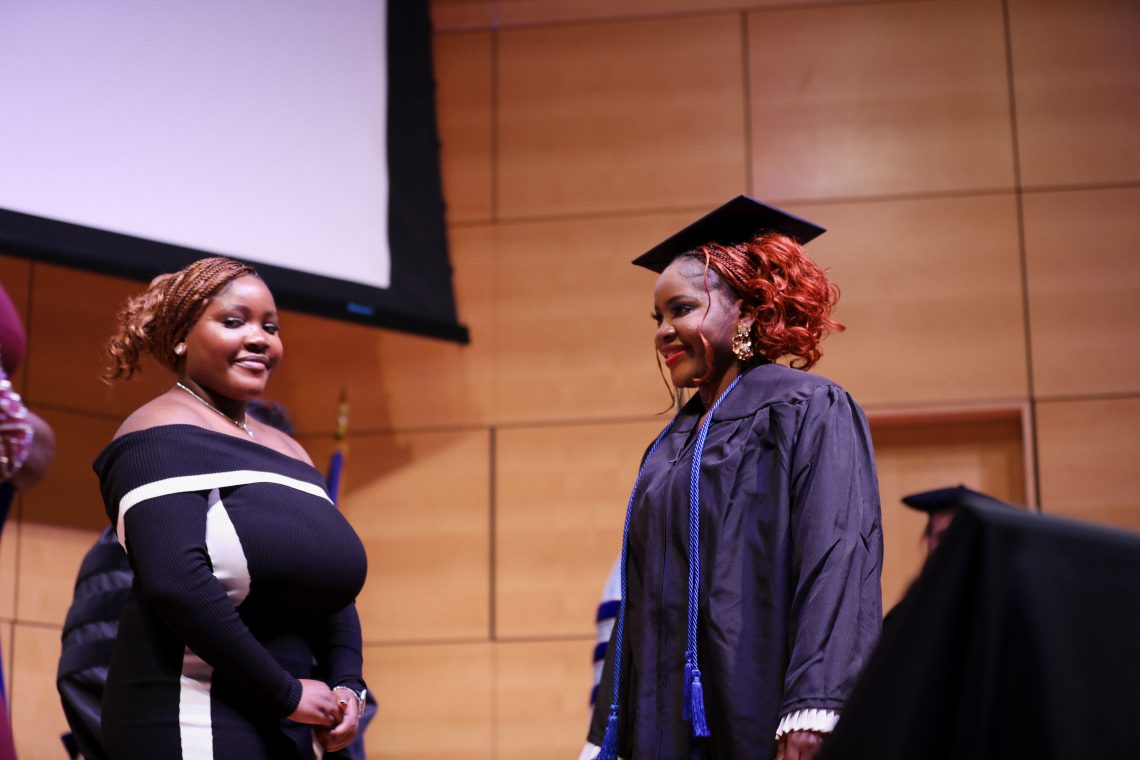 University of Southern Maine nursing graduate, Grace Atere prepares to be pinned with mother and sister.