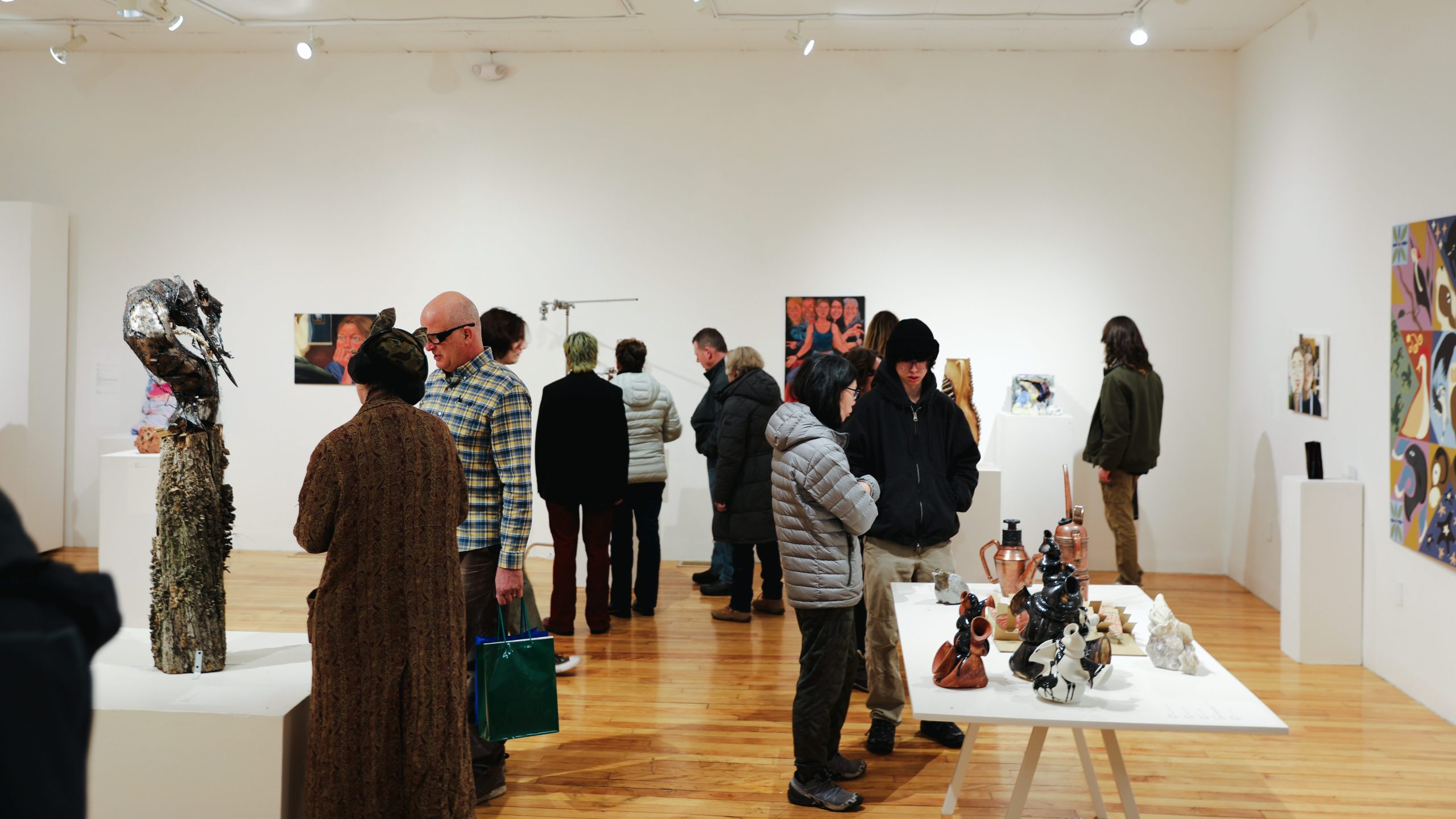 Visitors view student artwork inside the USM Gorham Art Gallery during the 2026 Juried Student Art Exhibition.
