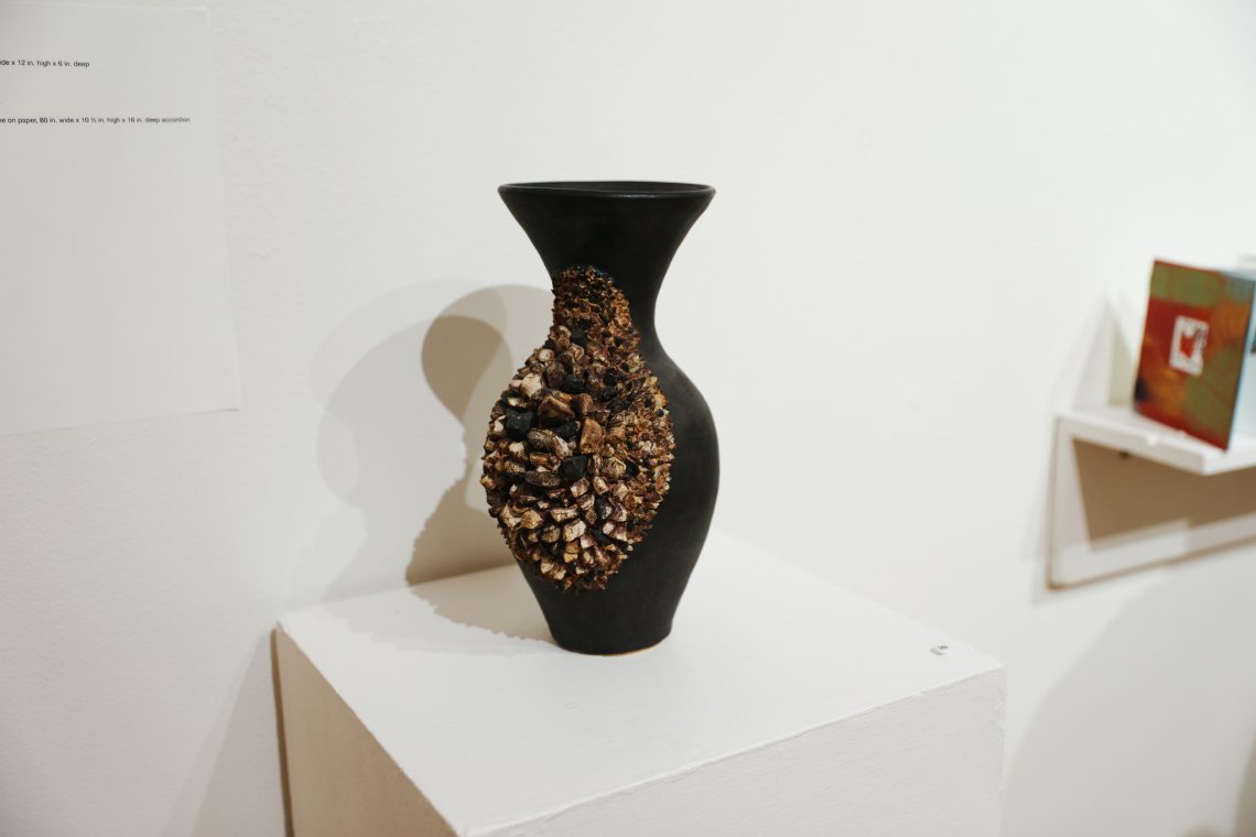 Crystal Reynolds’ ceramic vase titled "Cluster" on view at the 2026 Juried Student Art Exhibition.