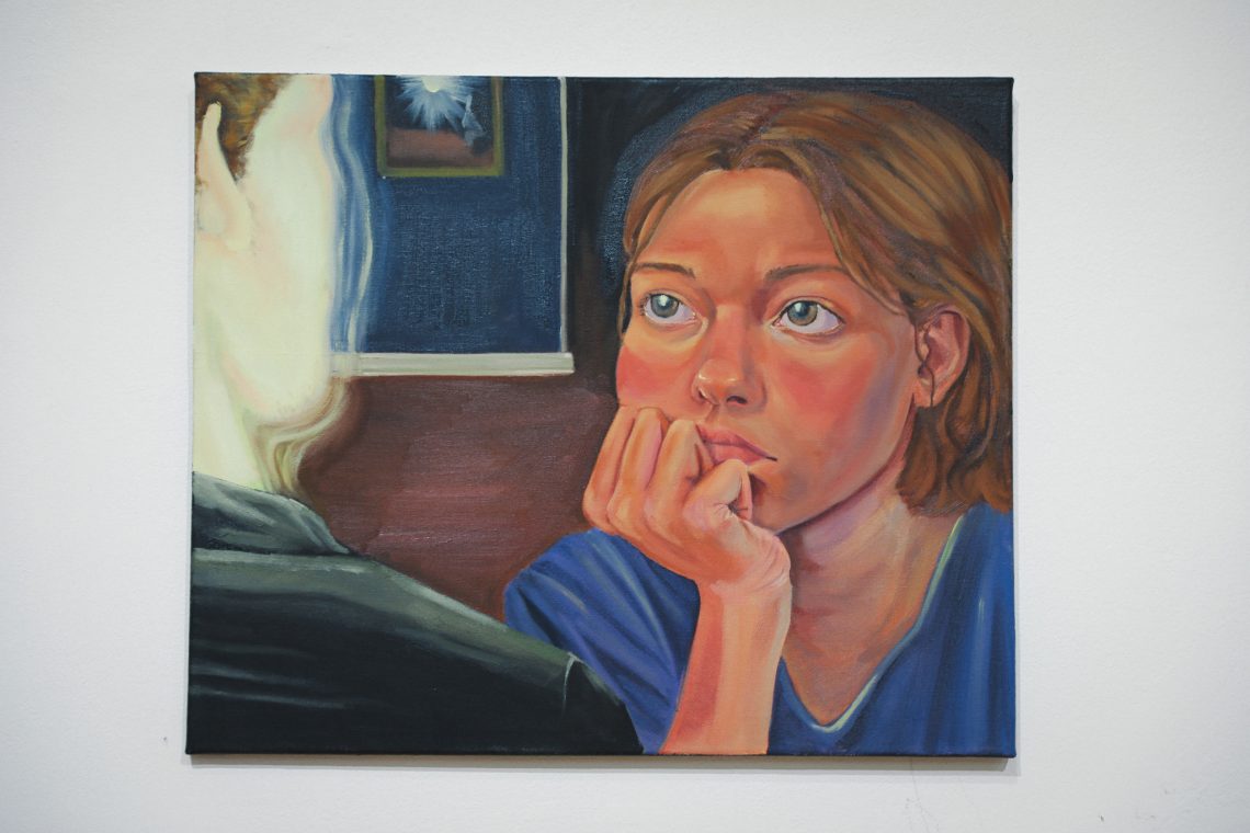 Whitney Davenport’s painting "Listening", depicting a girl sitting and listening, on view at the 2026 Juried Student Art Exhibition.