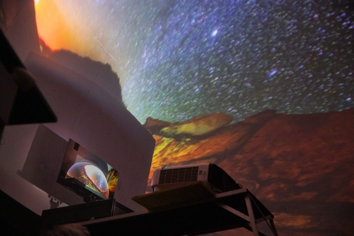 Pre-upgrade planetarium projector shining onto a mirror to reflect the image onto the dome.