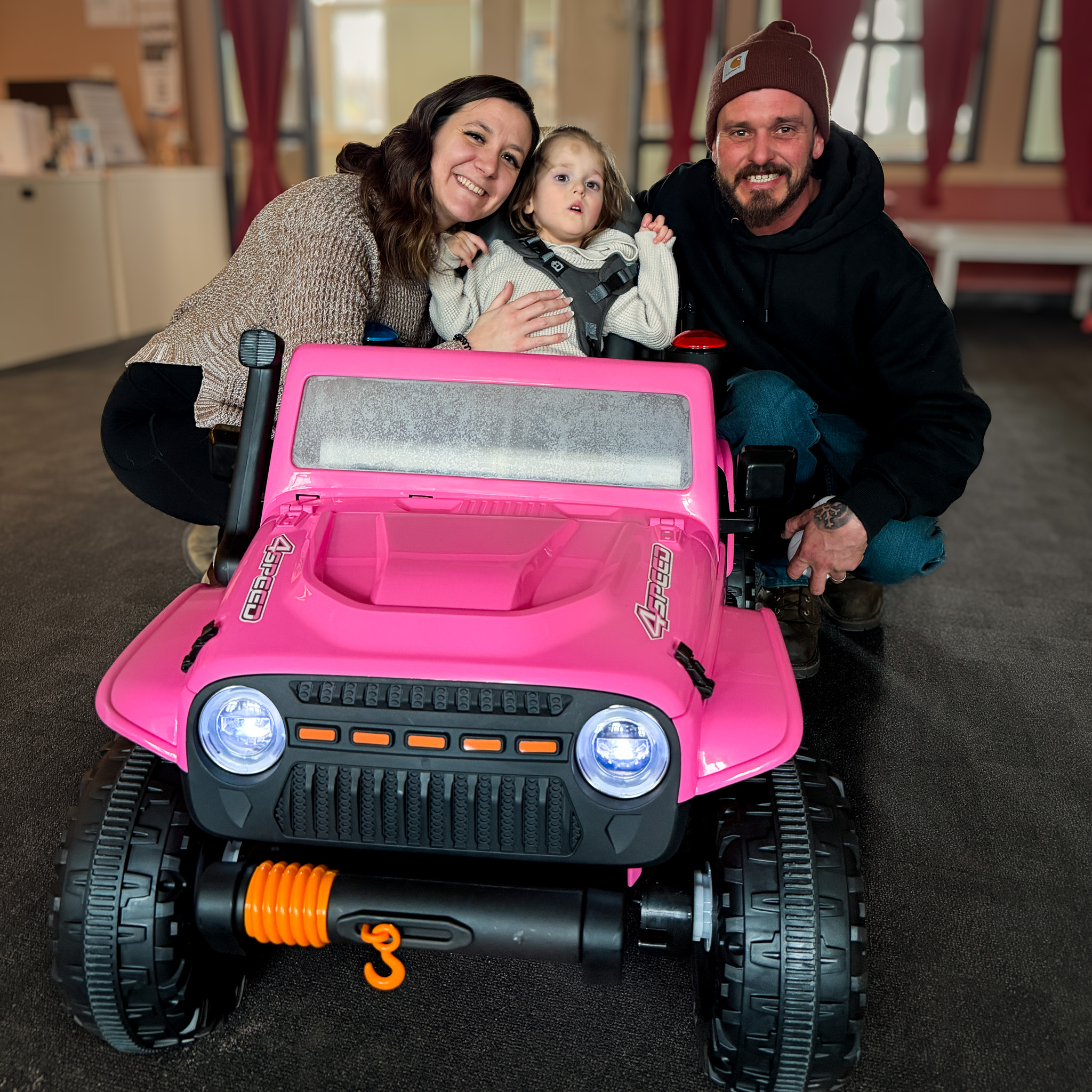 Aleigh, Atlas, and John showing off their new mobility optimized Jeep designed by Occupational Therapy and Engineering for Go Baby Go.