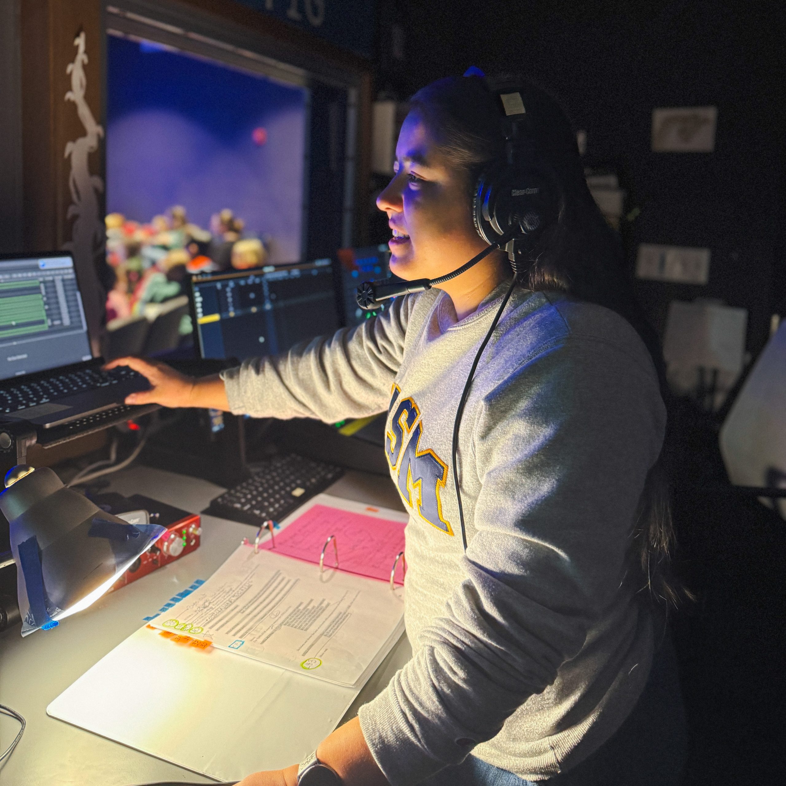 USM alumna Juliet Moniz works at the lighting control board in the technical booth during Stellaluna at the Children's Museum & Theatre of Maine, where she serves as rehearsal stage manager.