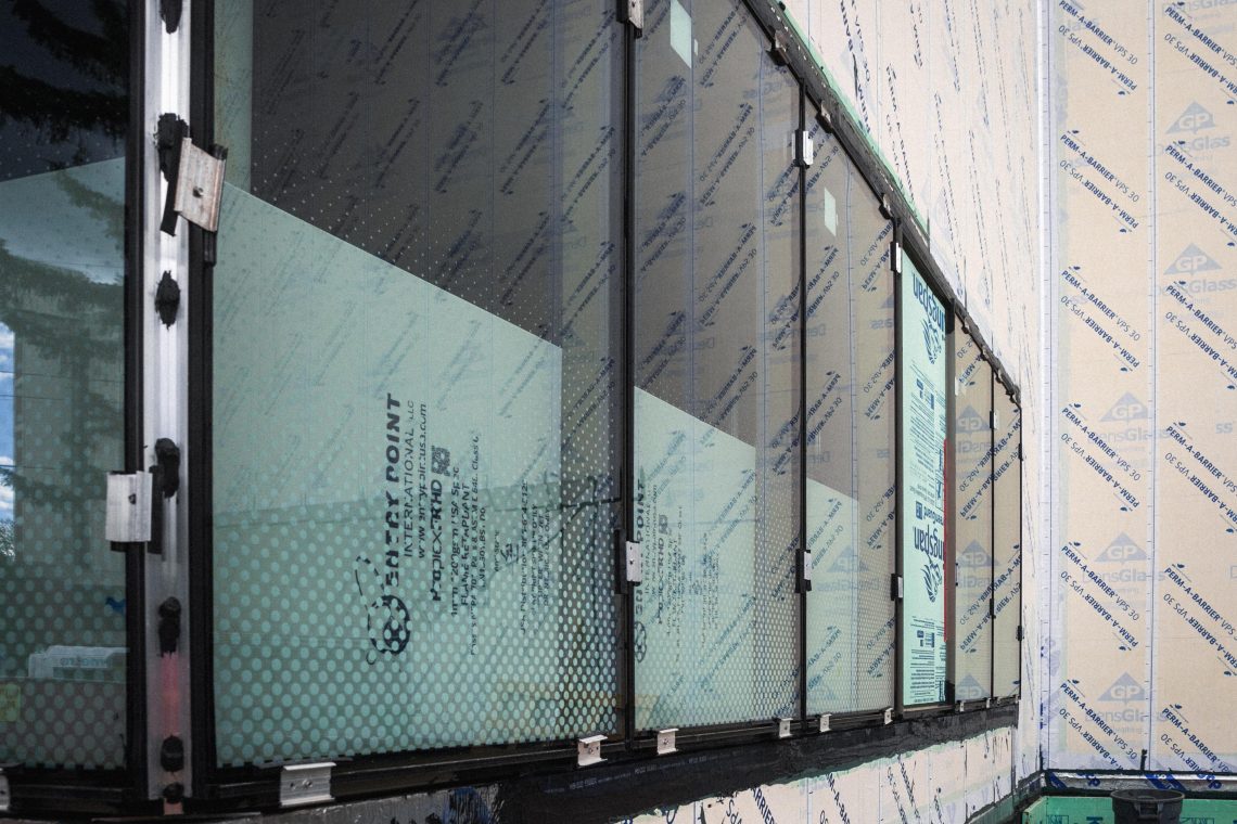 Close-up of bird-safe glass on the Crewe Center for the Arts, showing small etched dots designed to prevent bird collisions.