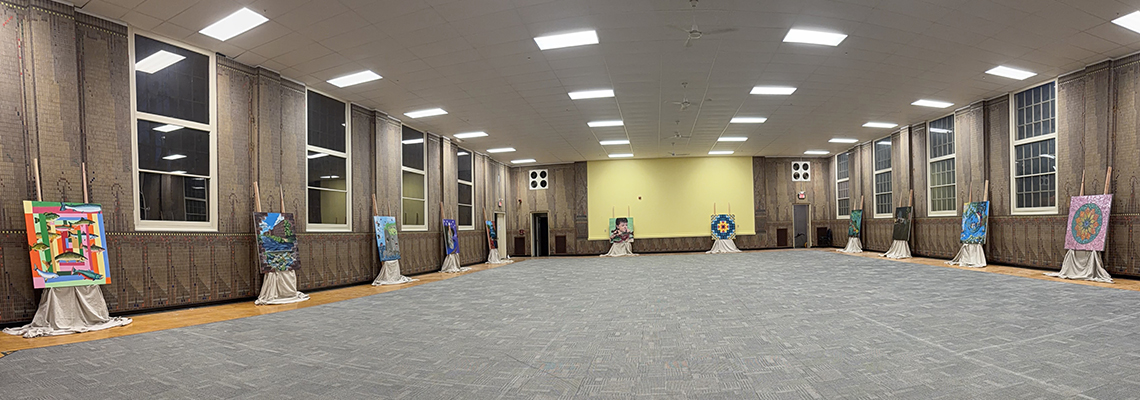 Photo of room with 4'X4' murals spread out for viewing.