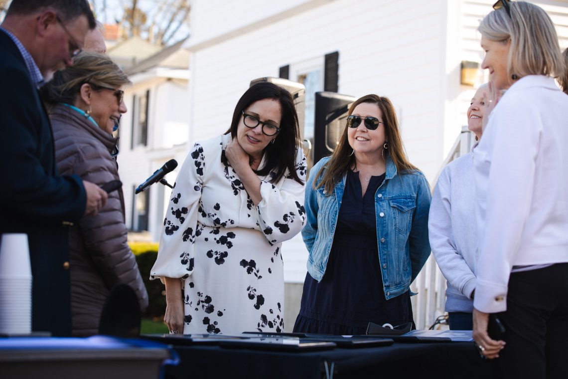 USM President Jacqueline Edmondson views the Veterans Row plaques alongside veterans' family members at the dedication ceremony on April 23, 2026.