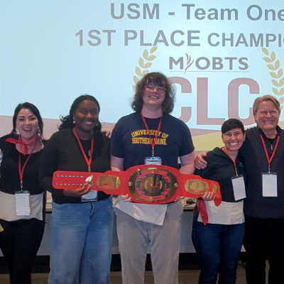 Group picture of the winning team holding the competition prize