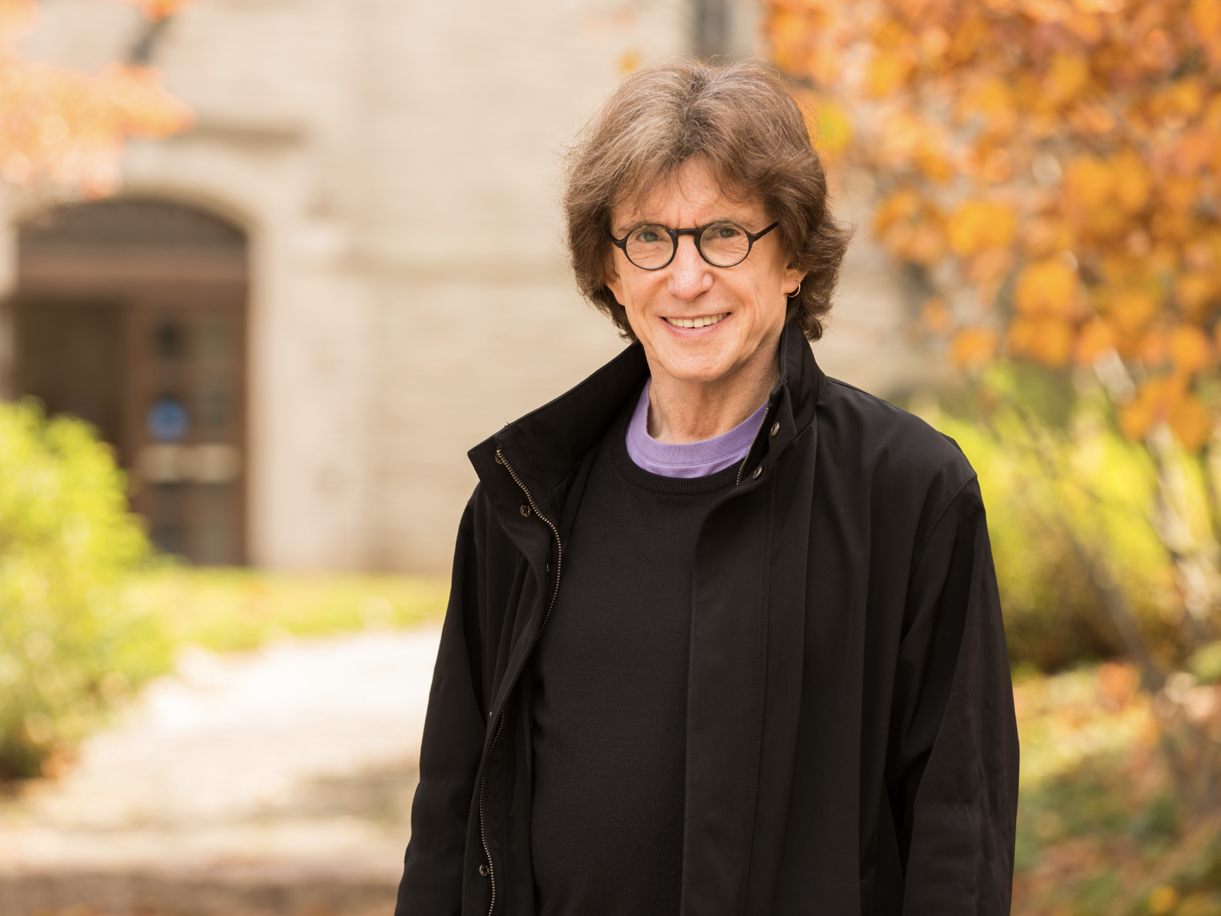 Headshot photo of Henry Giroux, USM 2026 Commencement Speaker, smiling with fall leaves in the background.